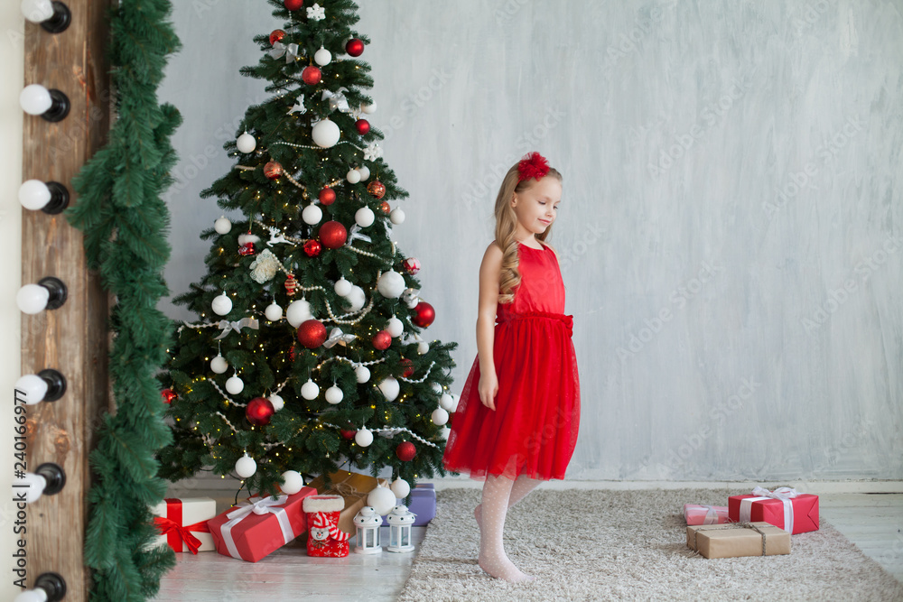 little girl opens Christmas presents new year tree little girl opens Christmas presents new year tree