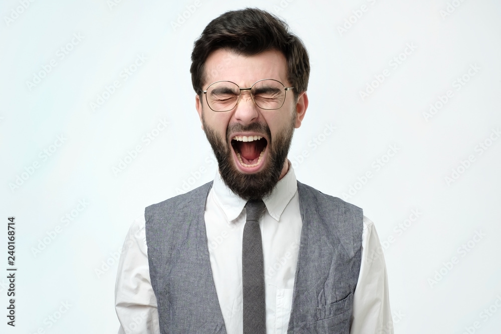 Angry spanish business man with beard screaming. Negative facial emotion. Angry spanish business man with beard screaming. Negative facial emotion.