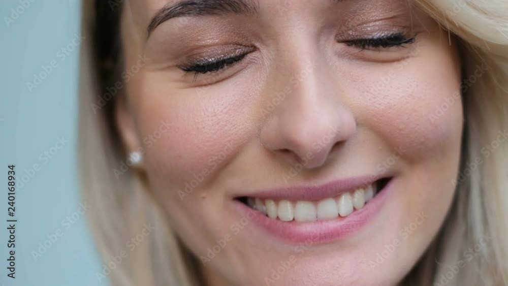 Close up portrait of attractive caucasian ethnicity young woman in urban environment. Girl showing her teeth, and make face, act, play the ape