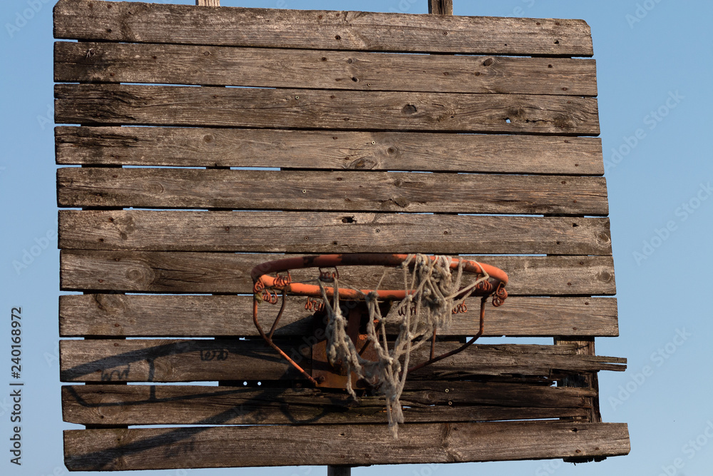 Old and rusty basketball hoop with tangled net, on an old wooden backboard  Stock Photo | Adobe Stock