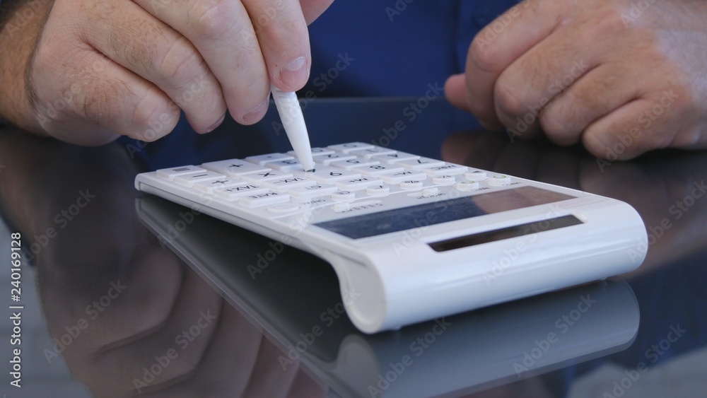 Businessman in Office Calculating Using Adding Machine Businessman in Office Calculating Using Adding Machine