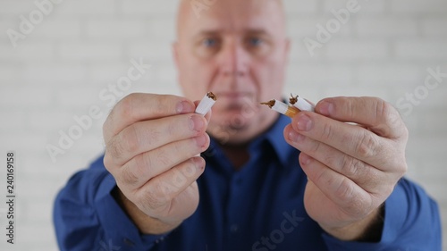 Man Presenting Anti Tobacco Campaign Showing and Breaking a Cigarette in Hands