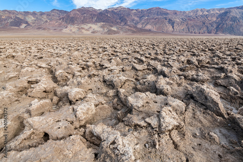 Salt formations and mountains at the Devil's Golf Course in Death Valley National Park, California, USA