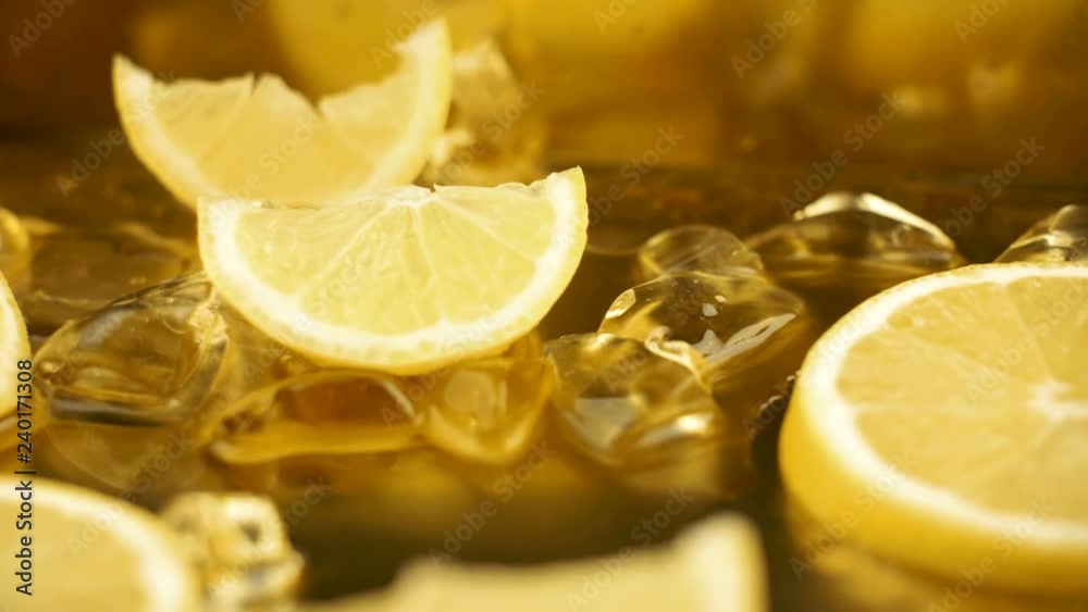 Fresh sliced lemon on gold metal surface with crystal ice and water. 4k close up footage. Fresh sliced lemon on gold metal surface with crystal ice and water. 4k close up footage.