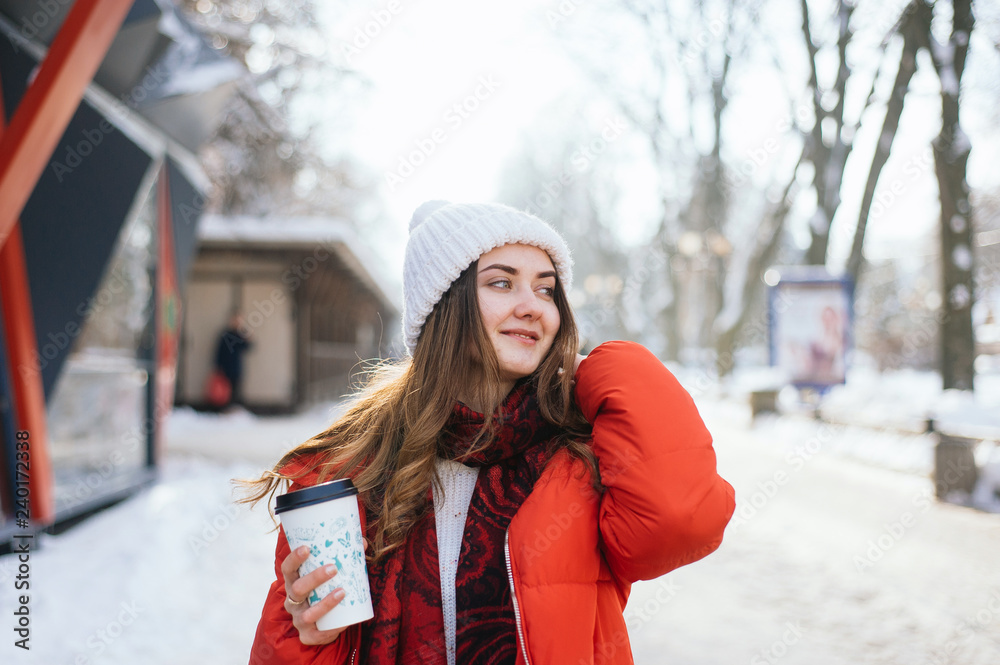 Portrait happy and beautiful girl in winter street