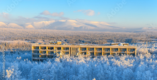 Winter landscape with snowy mountains in the background. Sunny day , blue sky, clouds. Apatity, Kola Peninsula.