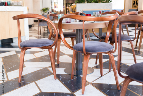 Designer chairs made of bent plywood in the interior of the cafe © spritnyuk