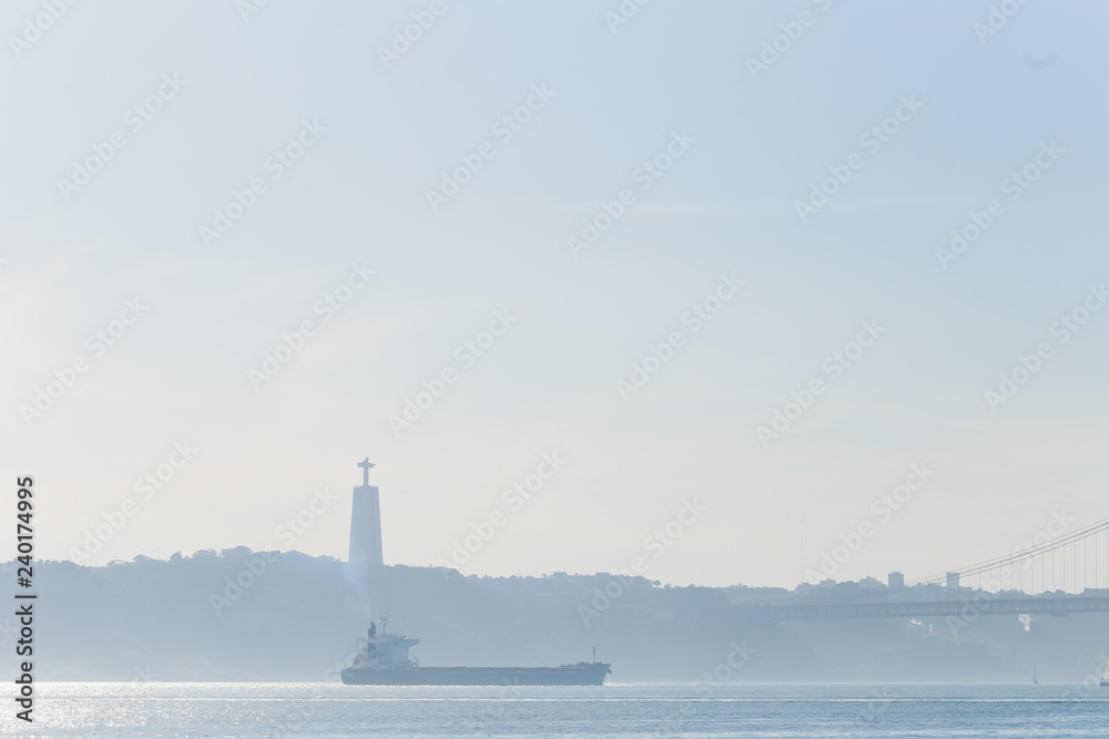 A picturesque river Tagus with a large ship. silhouette of the o
