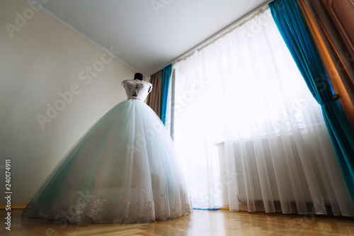 chic bride dress on the mannequin in the bright room with a larg
