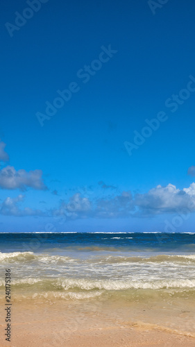 Soft Wave Of Blue Ocean On Sandy Beach. Background. Splash of waves on the sandy beach. foam  surf  waves