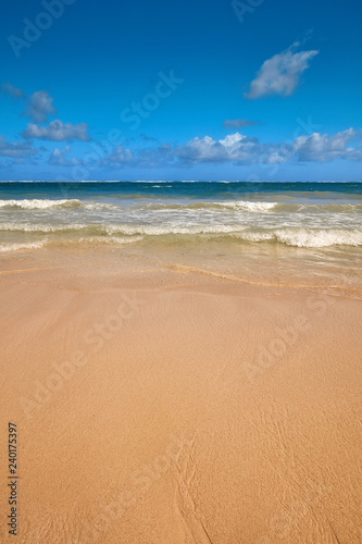 Soft Wave Of Blue Ocean On Sandy Beach. Background. Splash of waves on the sandy beach. foam, surf, waves