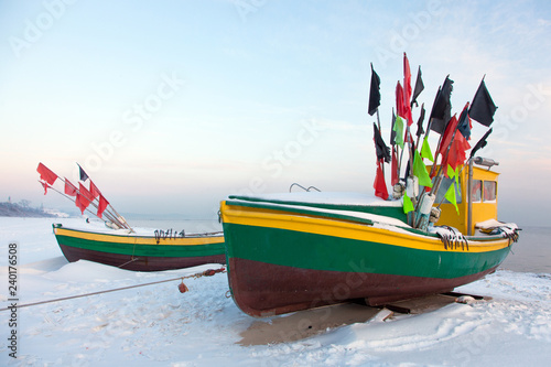 Fototapeta Naklejka Na Ścianę i Meble -  Podmorskie region, Poland - December, 2010: fishing boats on the beach in the winter, Baltic sea near Sopot town