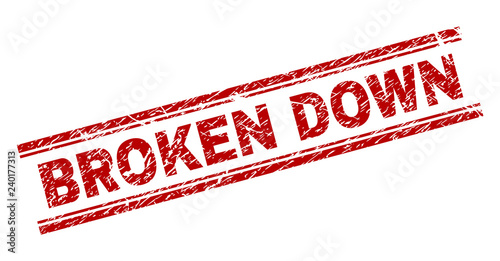 BROKEN DOWN seal print with grunge style. Red vector rubber print of BROKEN DOWN caption with grunge texture. Text tag is placed between double parallel lines.