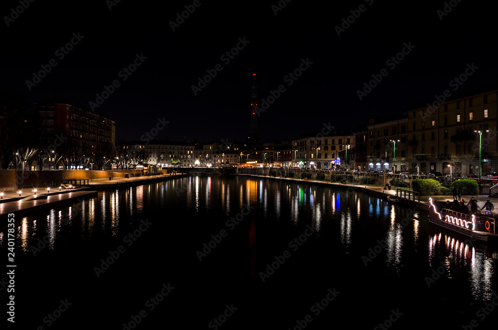 nigth in Navigli, cityscape of Navigli in Milan at night with light reflecting over the water