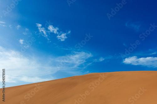 Detail of a sand dune against a blue sky at the Echoing Sand Mountain near the city of Dunhuang, in the Gansu Province, China.