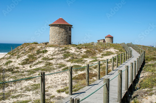 Old traditional wind-mills in sand-hills of Apulia Portugal