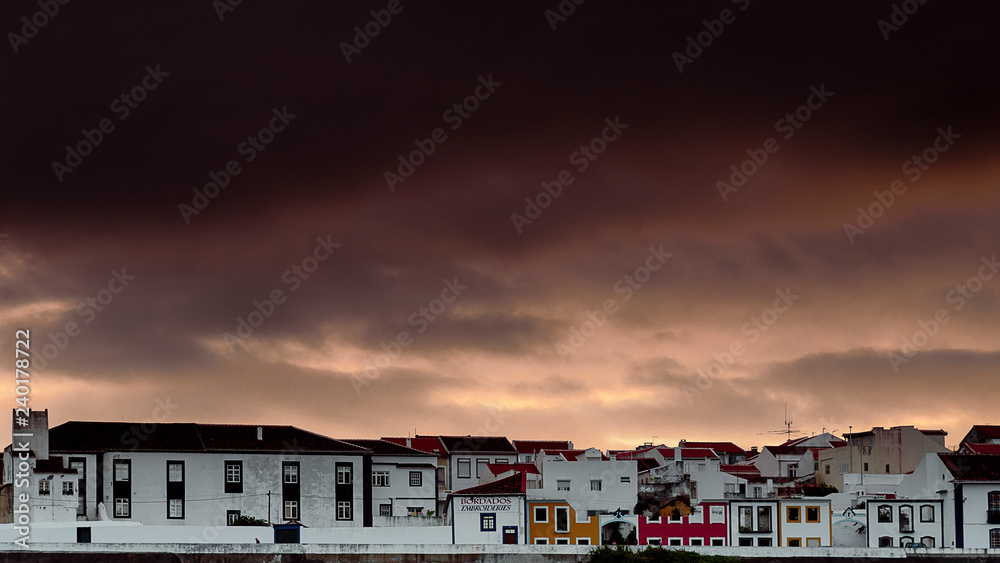 clouds and sunset over angra do heroismo, cityscape of angra do heroismo during a cloudy sunset. azores. portugal
