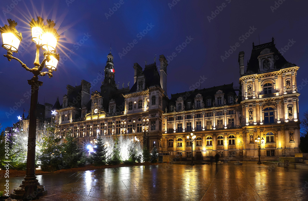 The city hall of Paris decorated with Christmas trees at night. Paris, France.