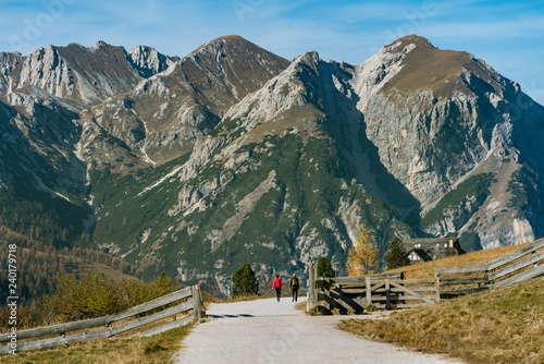 A man and woman hiking in the Fanes Sennes Prags Nature Park near Schluderbach Carbonin in the South Tyrol, Italy.