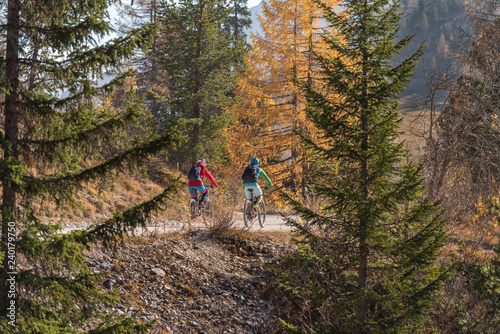 Two people on mountain bikes in the Fanes Sennes Prags Nature Park near Schluderbach Carbonin in the South Tyrol, Italy.