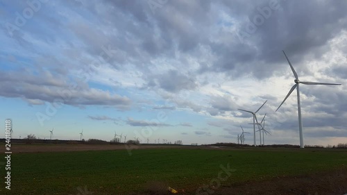 Aerogeneradores con las Aspas en movimiento con fondo de cielo con nubes al atardecer photo