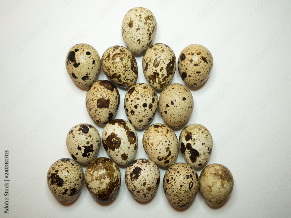 Group quail eggs on a white background