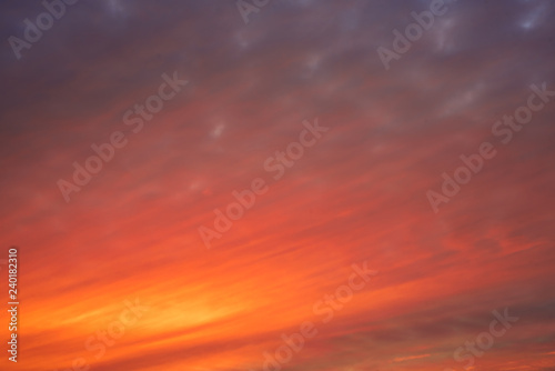 Dramatic and colorful sunset sunrise with clouds. © Lalandrew