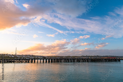 Beautiful sunset at the dock. Blue sky and Ocean with town view. Omaru  New Zealand.