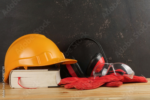 Safety Personal Protective Equipment(PPE) on a rustic black background.