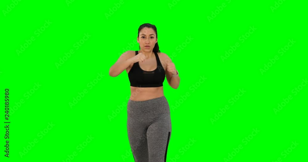 Young Hispanic woman doing high energy cardio boxing workout Young Hispanic woman doing high energy cardio boxing workout