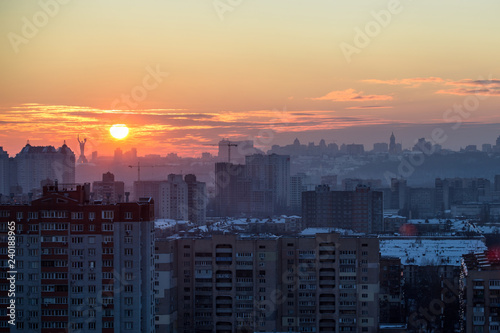 Sunset in Kiev, evening view of the panorama of the city, the church and the statue of the Motherland. Evening color urban landscape
