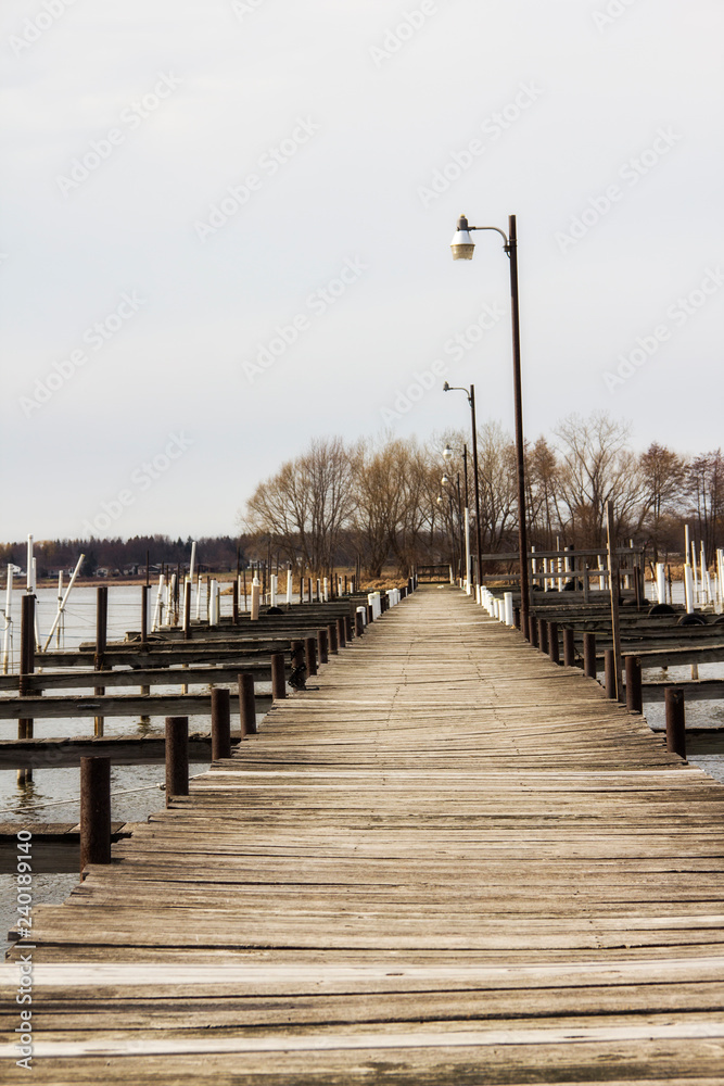 wooden dock with light posts on a lake