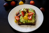 Healthy green veggie avocado toast with tomatoes