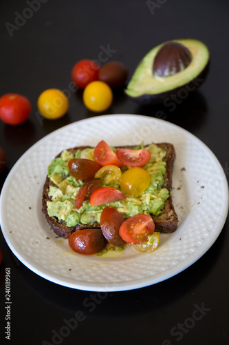 Healthy green veggie avocado toast with tomatoes
