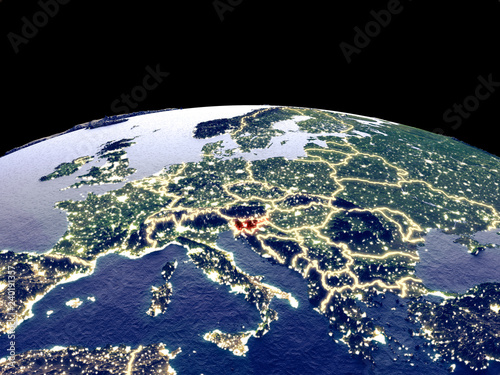 Fototapeta Naklejka Na Ścianę i Meble -  Slovenia from space on planet Earth at night with bright city lights. Detailed plastic planet surface with real mountains.