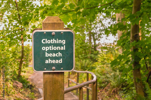 Slika na platnu Clothing optional sign on post on trail to beach, British Columbia