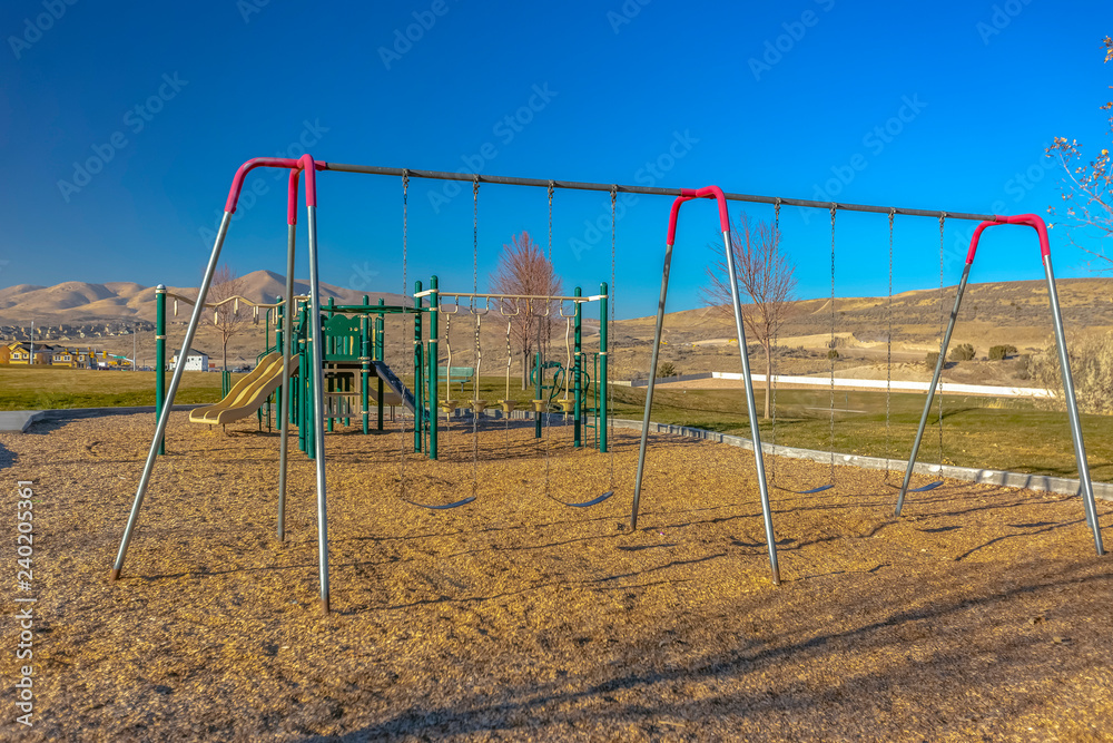 Swingset with empty swings at playground in Utah Swingset with empty swings at playground in Utah