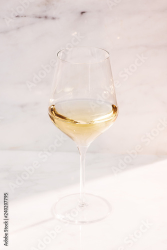 single white wine glass on marble