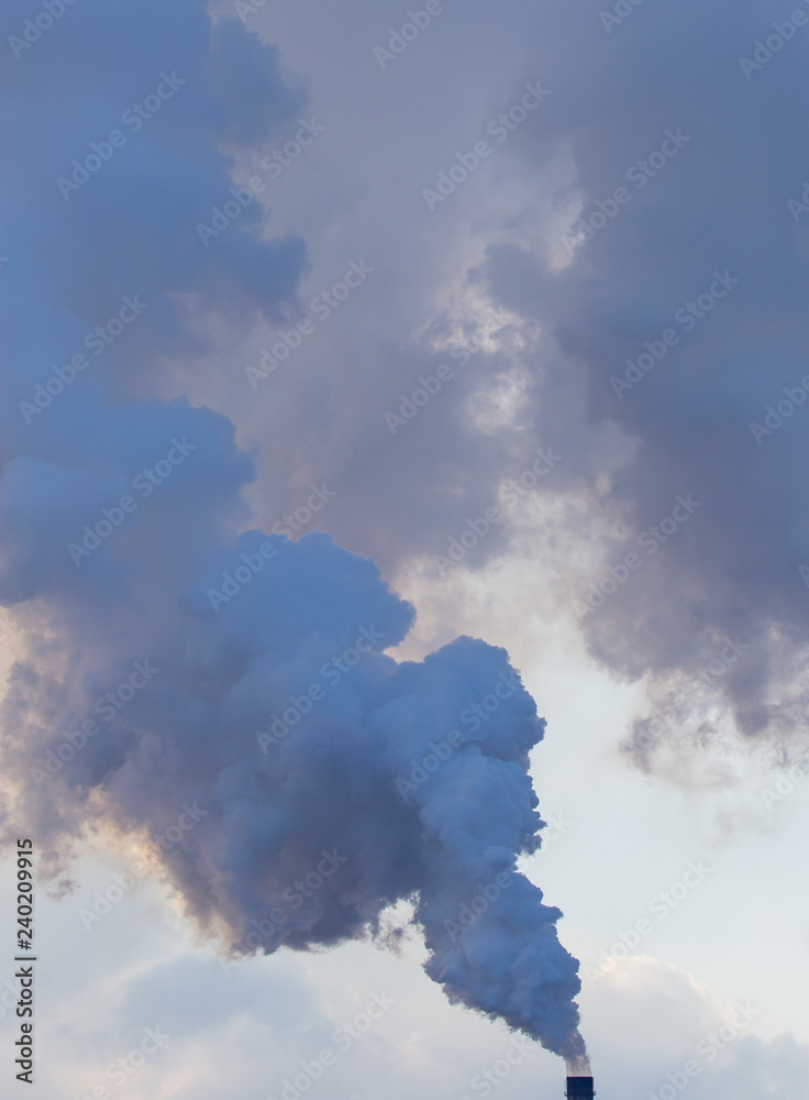 Smoke from pipes in a factory pollutes nature