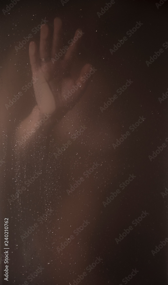  woman in the shower through the glass.
