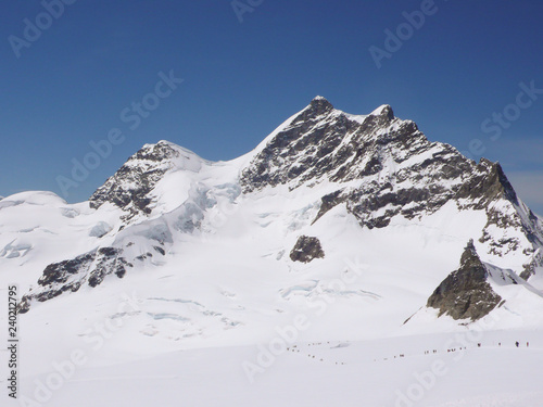 many day hikers and tourists on the glacier at Jungfraujoch above Grindelwald in Switzerland