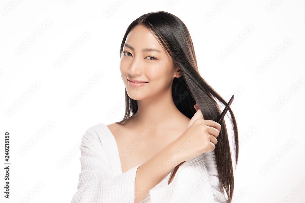 Portrait of beautiful young woman combing her hair. Portrait of beautiful young woman combing her hair.