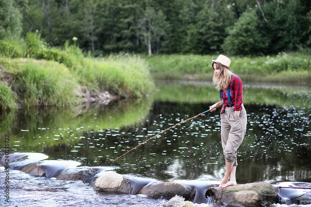 Girl by the river with a fishing rod Girl by the river with a fishing rod