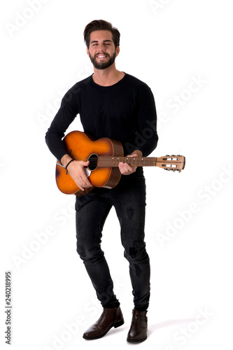 Full Length Portrait of Young Man Wearing Black Outfit Playing Classic Guitar in Studio with White Background
