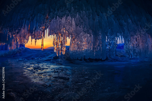 sunset in a cave grotto with icicles in the winter on Olkhon Island, Lake Baikal