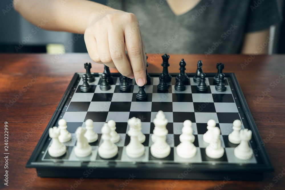 Businessman holding a King Chess is placed on a chessboard.using as background business concept and Strategy concept with copy space for your text or design. Businessman holding a King Chess is placed on a chessboard.using as background business concept and Strategy concept with copy space for your text or design.