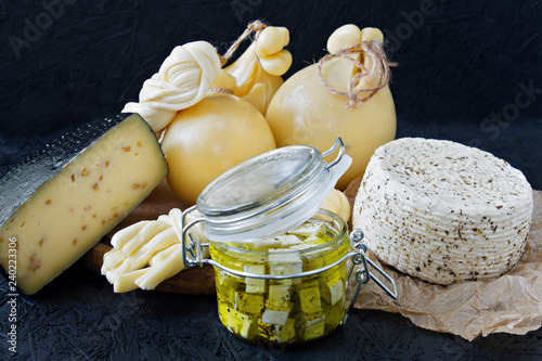 Different types of cheese on a black background. Cheese platter photo