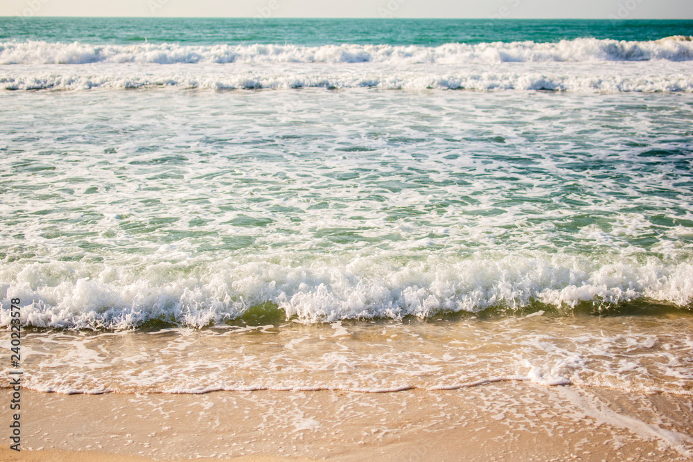 Soft beautiful ocean wave on sandy beach.