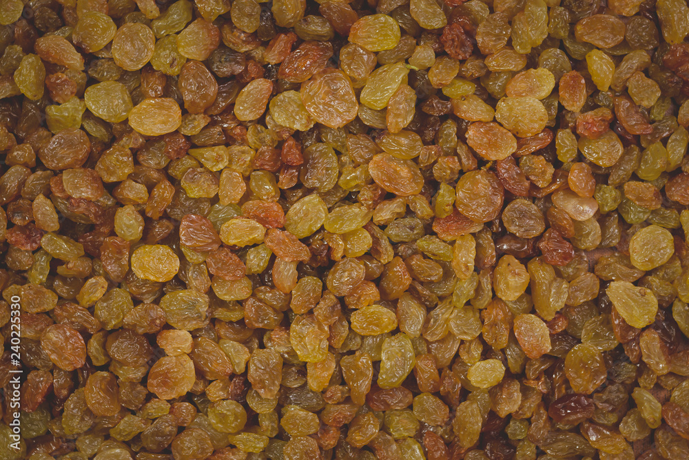 Golden and brown raisins closeup, texture, background Golden and brown raisins closeup, texture, background