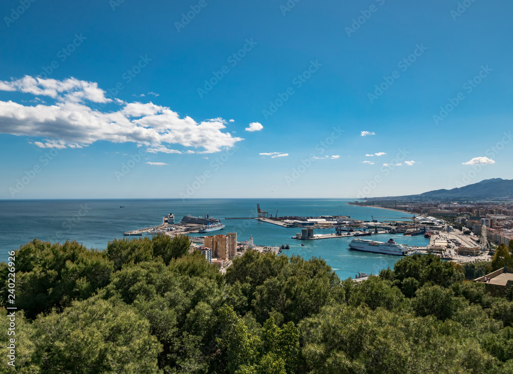 View from the Gibralfaro castle on a sunny day. Panorama view of the city skyline, the port and cruise ships